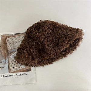 Detailed texture of a dark brown teddy plush bucket hat with thick warm fleece surface