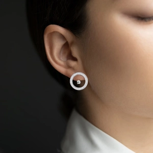 Close-up of sparkling 925 sterling silver hoop earrings with pave cubic zirconia on model