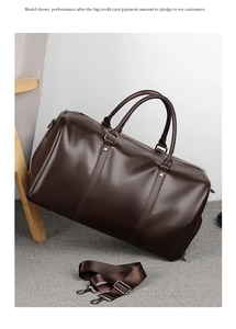 Detail of dark brown leather duffel bag with lychee texture and detachable shoulder strap