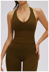 Close-up of olive green V-neck sports bra and high-waist leggings on a fitness model