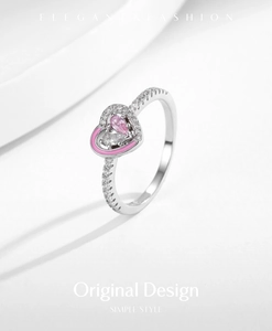 Detail of s925 silver heart ring with pink enamel and sparkling pavé diamonds