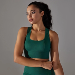 Detail of dark green seamless sports bra showing honeycomb breathable texture and wide straps