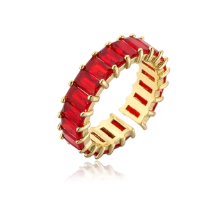 Macro detail of gold plated ring featuring rectangular red zircon with claw setting