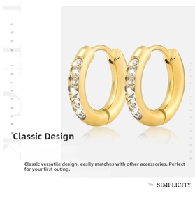 Macro detail of gold hoop earrings with micro-paved zircons and reflective finish