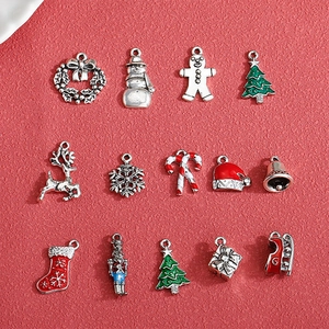 Christmas alloy pendant set with reindeer and tree charms on red textured background