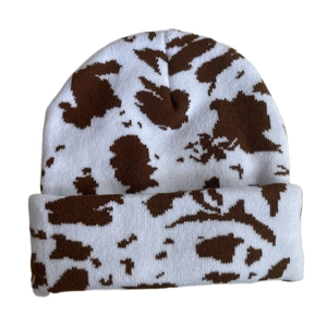 Close-up of the cow print pattern and thick knit texture on the warm winter beanie