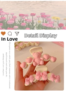 Detail of pink resin hair claw clips with smile bear and bow design for women