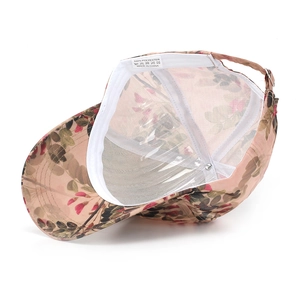 Inside view of pink floral baseball cap featuring 100% polyester fabric and metal buckle