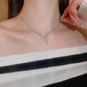 Close-up of sparkling silver snake Y-shaped tassel necklace with cubic zirconia