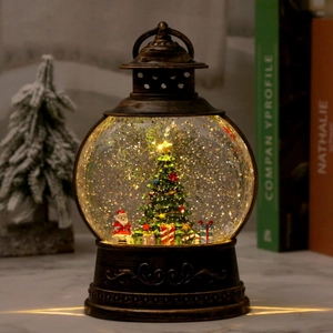 Vintage bronze Christmas lantern with Santa and tree inside glowing in warm light