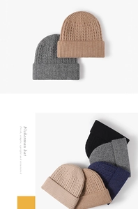 Close-up of thick knitted beanie hats featuring textured ripple patterns and cuffed edges
