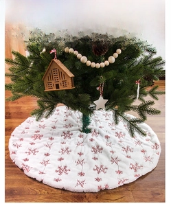 Detailed embroidery of red snowflakes on premium white faux fur Christmas tree skirt decor