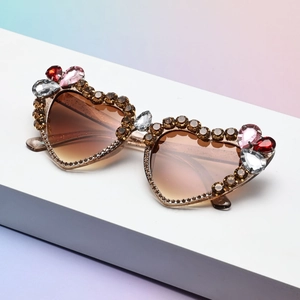 Macro shot of heart sunglasses with brown rhinestones and colorful crystal drop accents