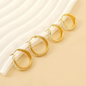Elegant gold titanium steel hoop earrings featuring crystal pave detailing for women