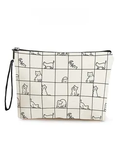 Close-up of zipper closure and checkered cat pattern on the canvas cosmetic bag