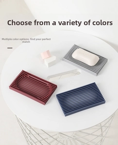 Detailed view of flexible silicone soap holders with striped drainage in three colors