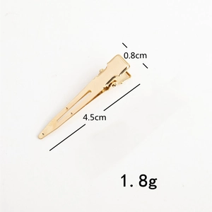 Macro shot showing dimensions of a 4.5cm golden metal duckbill hair clip accessory
