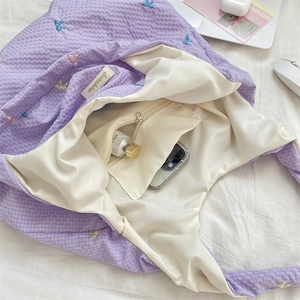 Detailed interior of purple plaid tote bag showing zip pocket and large capacity