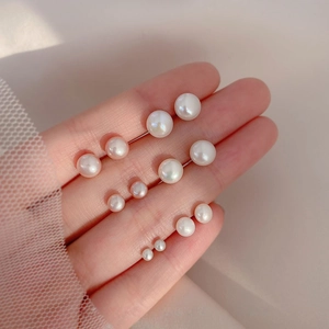 Five pairs of elegant white faux pearl earrings in various sizes for women