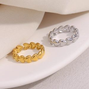 Close-up of interlocking heart-shaped rings in gold and silver finish with metallic shine