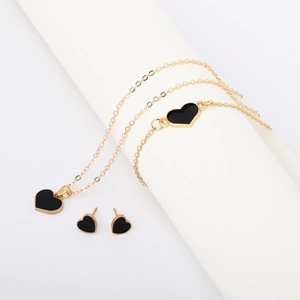Golden jewelry set with black heart pendants including necklace bracelet and earrings