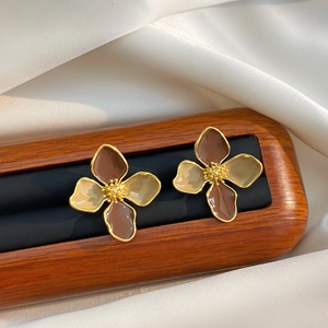 Vintage floral enamel earrings in gold metal with brown petals on silk backdrop