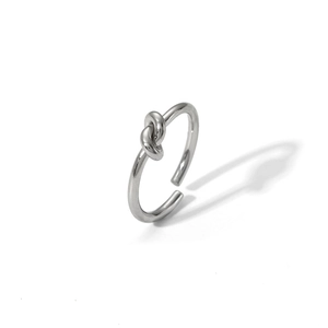 Macro view of adjustable silver knot ring showing polished stainless steel finish