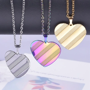 Polished 18k gold and rainbow heart necklaces with diagonal textured stripe patterns