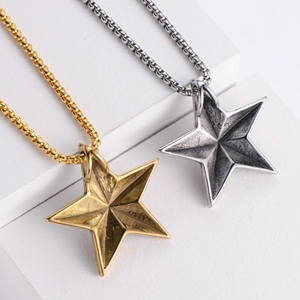 Detailed view of vintage star pendants in gold and silver finish with square pearl chains