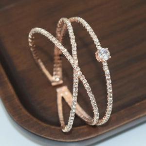 Macro shot of rose gold multi-layered bangle with sparkling zircon pavé and large center stone