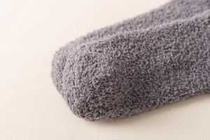 Macro shot of grey coral fleece sock toe area highlighting soft and fuzzy plush texture