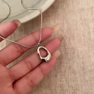 Minimalist silver snake chain necklace with an irregular hollow liquid metal pendant