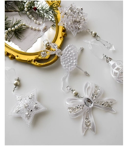 Detailed view of white acrylic Christmas tree ornaments with pearls and glitter