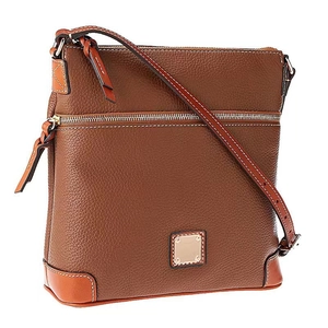 Macro view of brown pebble grain leather texture and gold zipper on crossbody bag