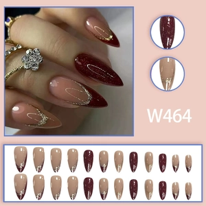 Deep red glitter and nude French press-on nails with gold accents in 24-piece almond set