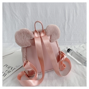 Detail of pink plush backpack showing soft faux fur texture and cute round animal ears