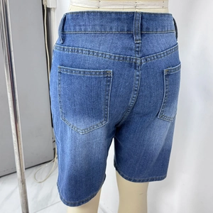 Detail view of denim capri shorts featuring contrast stitching and rear patch pockets