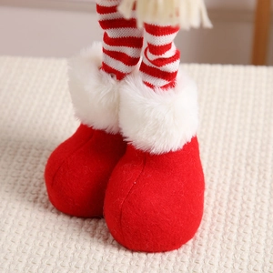 Detailed view of telescopic Christmas doll legs in red white stripes with soft faux fur