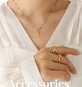 Detail showing tulip pendant necklace with crystal beads and gold finish ring set