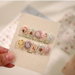 Detailed close-up of cute hand-painted animal nail stickers with a matte texture