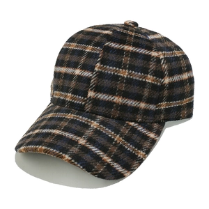 Detail of classic brown plaid wool baseball cap with vintage pattern and thick texture