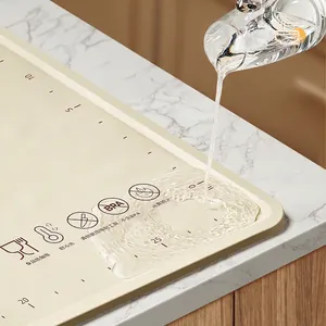 Off-white food-grade silicone baking mat with spill-proof raised edges and scale markers