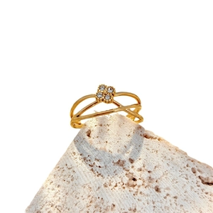 Minimalist gold multi-layer crossover ring with four-leaf clover crystal cluster on white stone