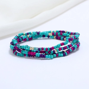Close-up of double-layered beaded waist chain in turquoise, magenta and metallic gold