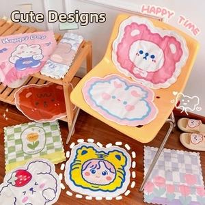 Collection of cute cartoon cushions and pink rabbit blanket in a cozy home setting