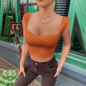 Detailed close-up of orange square-neck crop top showing rib-knit texture and slim fit