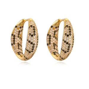 Detail of gold hoop earrings with black and white zircon leopard pattern pave setting