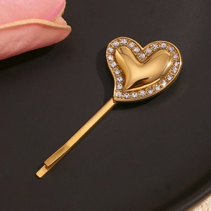 Detailed close-up of 18K gold plated heart hair clip with crystals on black background