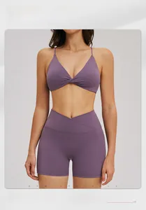 Detail view of purple yoga set featuring cross-twist sports bra and V-waist gym shorts