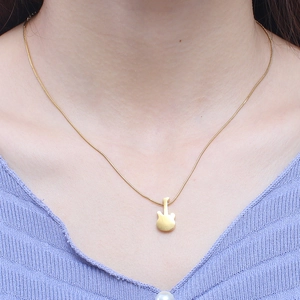 Minimalist gold guitar pendant necklace on model made of polished stainless steel